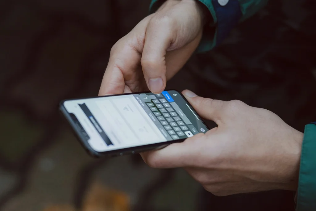 A person holding a phone, ready to make a call