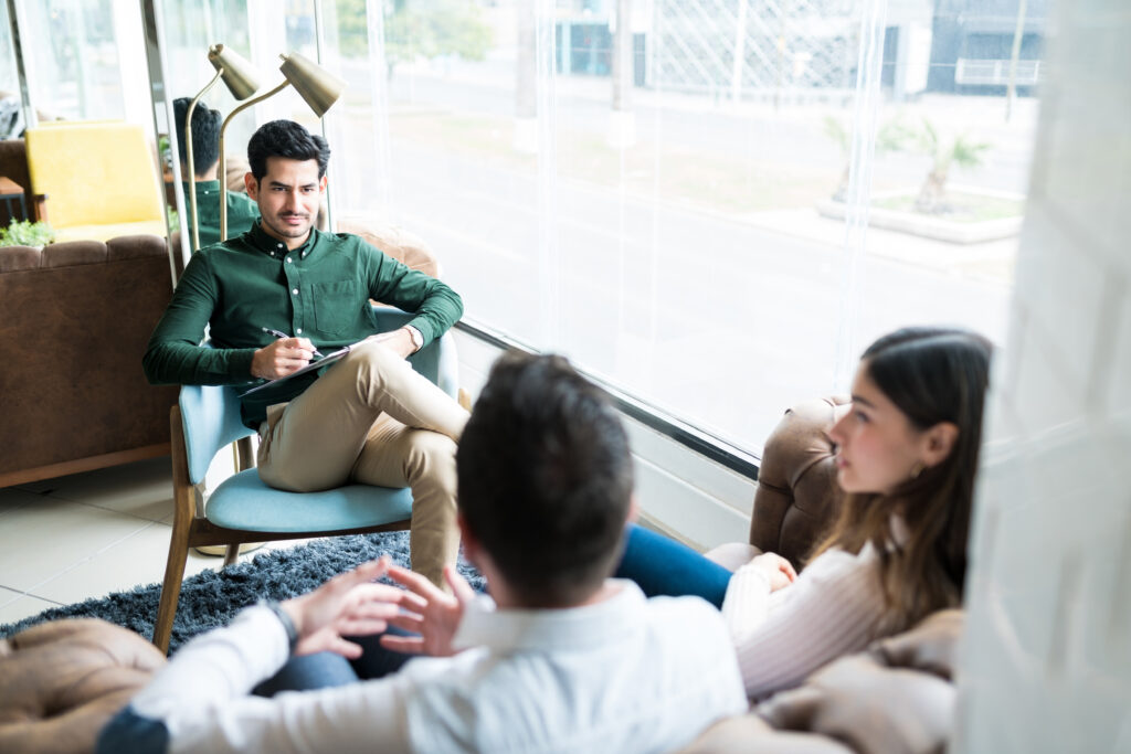 A counselor and client talking in a sunny office